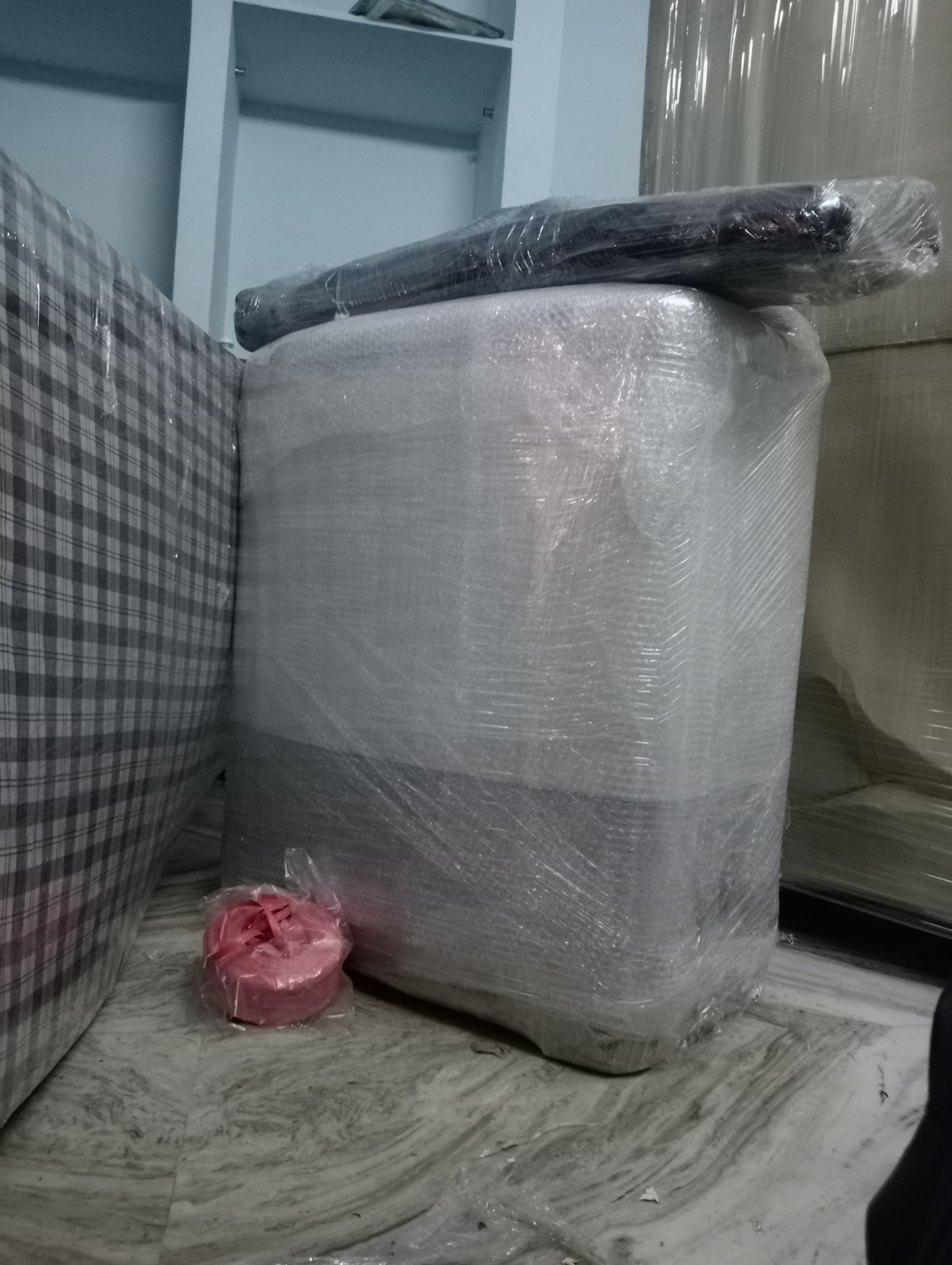 Unloading a refrigerator at a new apartment